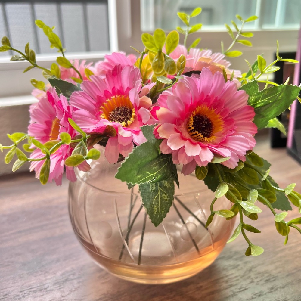 Faux flowers pink in glass vase